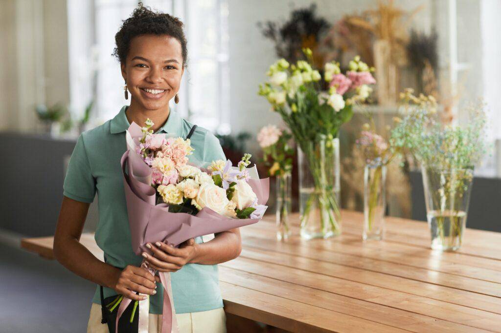 Young Woman Holding Flowers in Shop